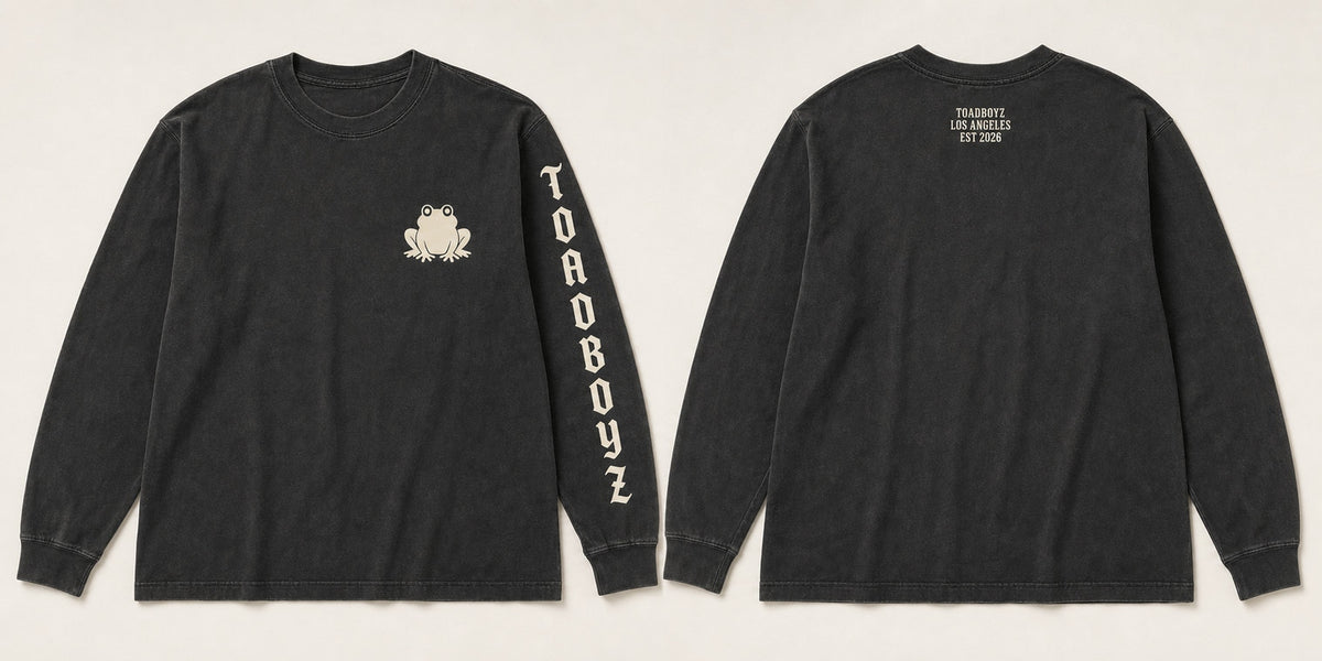 Frögy Heavyweight L/S · Drop 001. Washed black, bone-cream toad chest hit, sleeve wordmark, back yoke micro type.