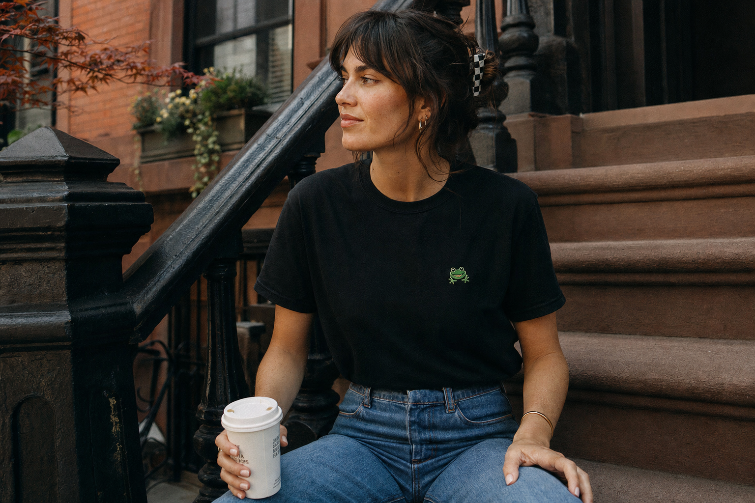 Lifestyle — black tee with toad mark, brownstone steps